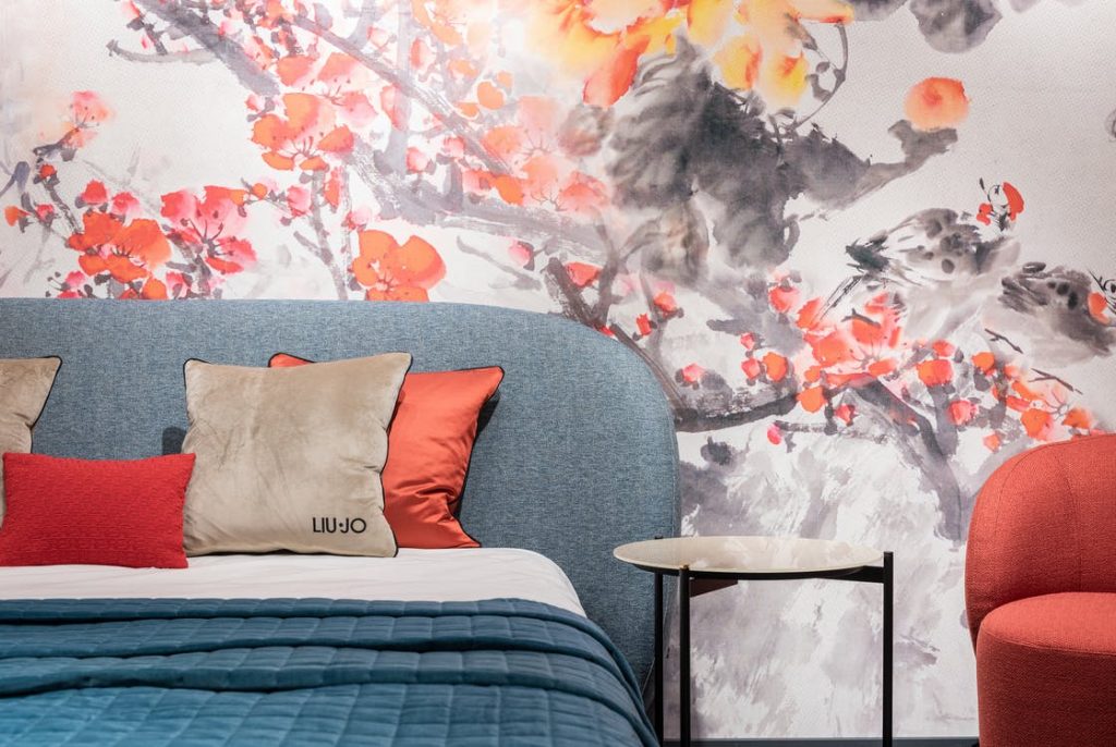 a bedroom with a vibrant wallpaper